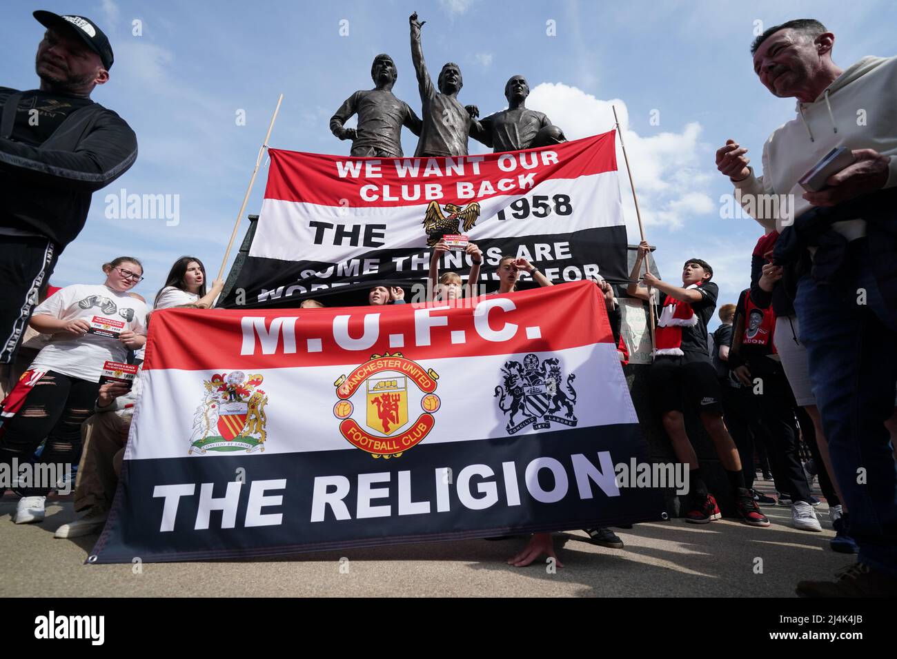 Manchester United fans in a protest against the team's ownership next to  the Trinity statue before the Premier League match at Old Trafford,  Manchester. Picture date: Saturday April 16, 2022 Stock Photo - Alamy