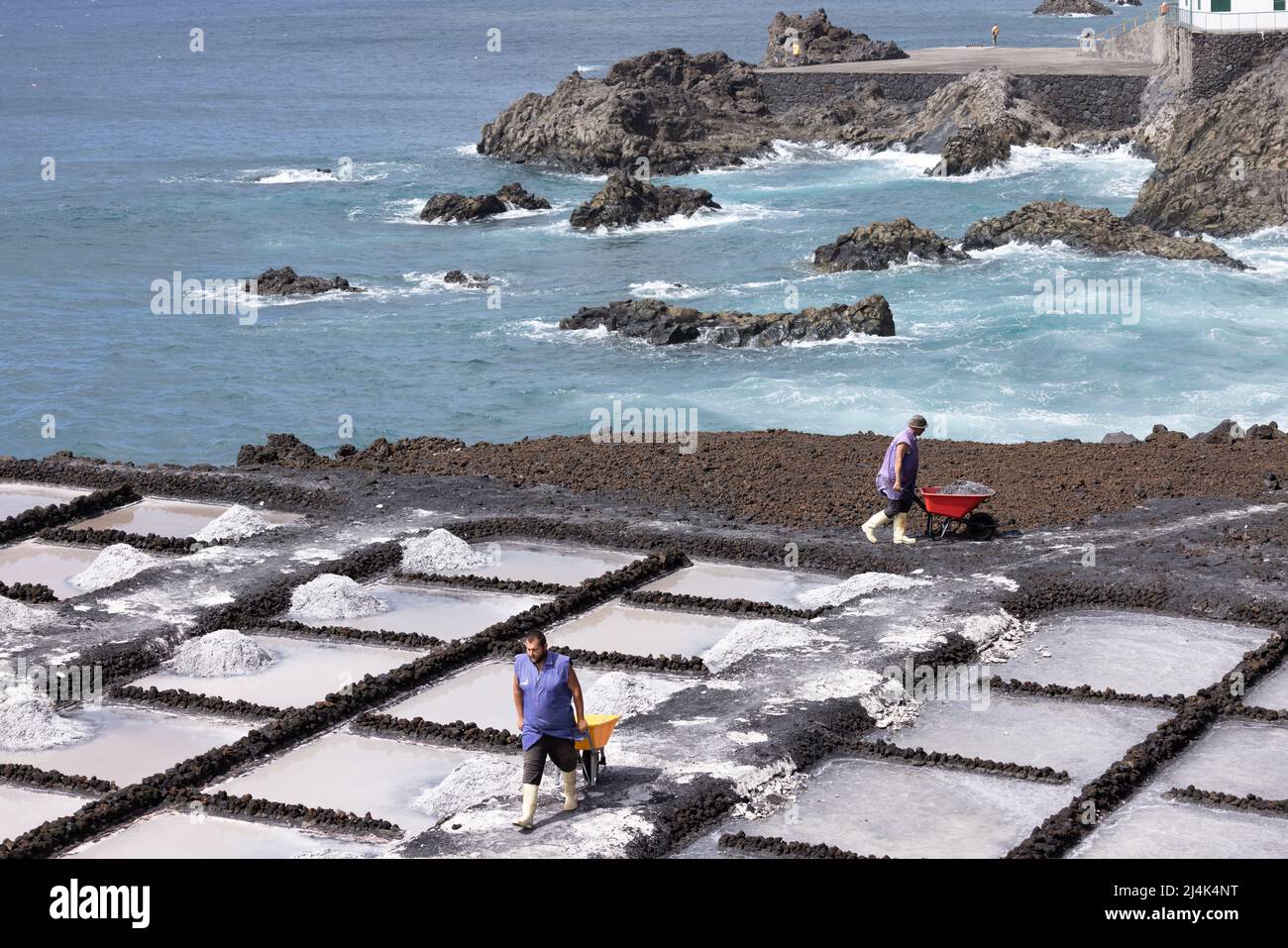 La Palma Island Spain - March 04, 2022: Workers at salt extraction near Fuencaliente at La Palma Island Stock Photo