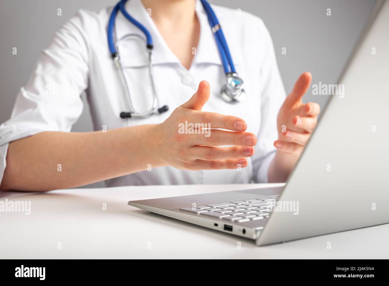 Doctor with stethoscope giving online consultation to patient ...