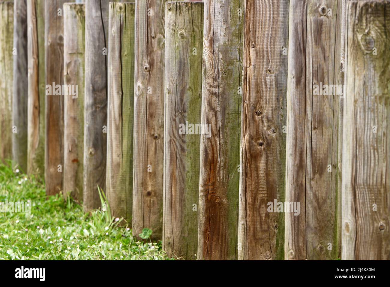 Wooden posts embedded in the ground to form a fence at the border of a park close up Sardinero Santander Cantabria Spain Stock Photo