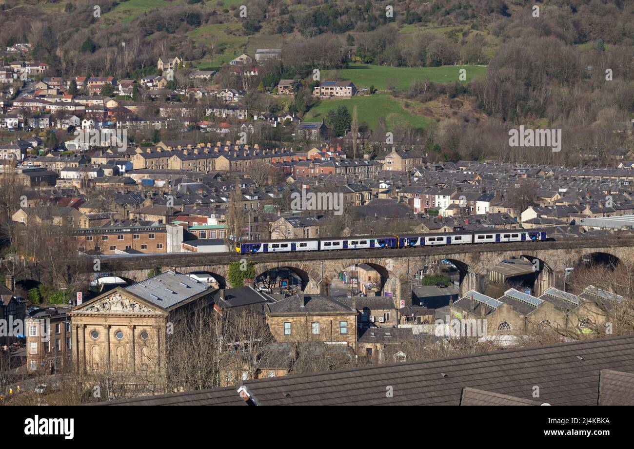 Todmorden Viaduct, Yorkshire, UK Northern Rail class 150 trains crossing above the roof tops  passing  the town hall Stock Photo