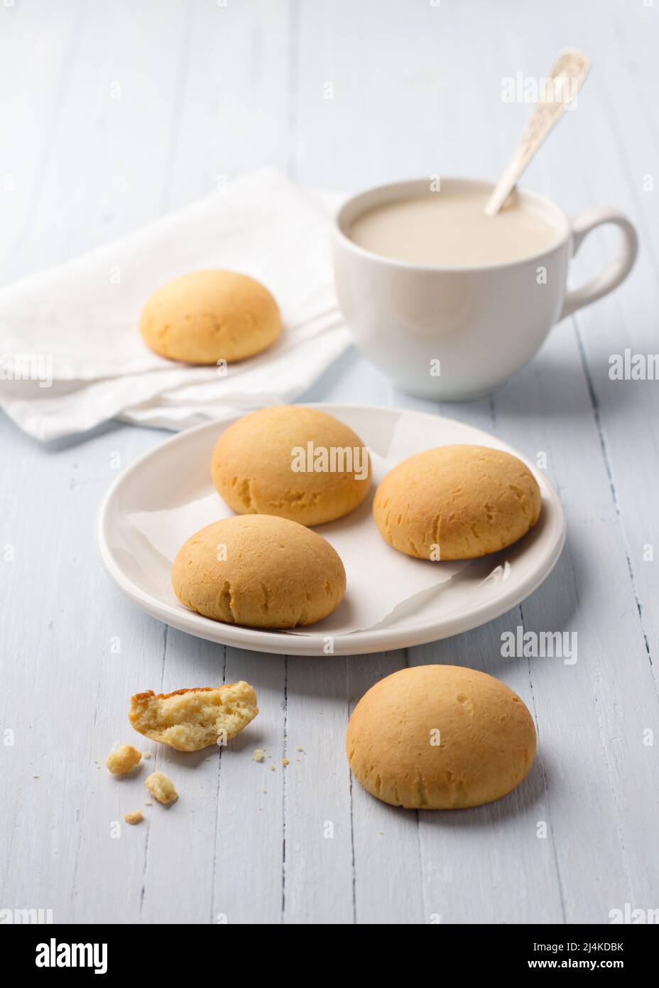 Homemade gluten free cottage cheese rice cookies and cup of tea with milk on light background