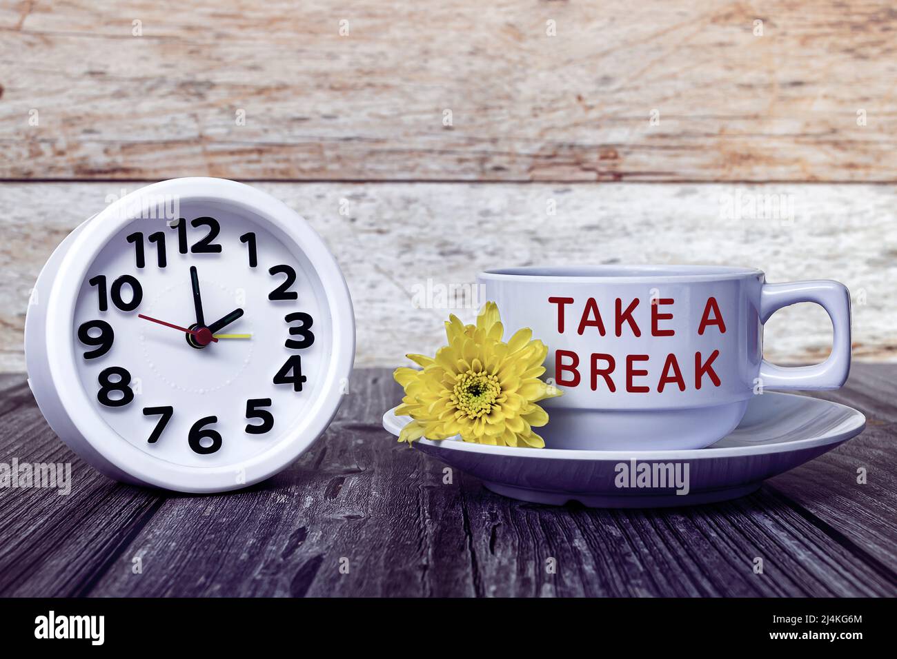 Take a break text written on white coffee cup with alarm clock set at 2 ...