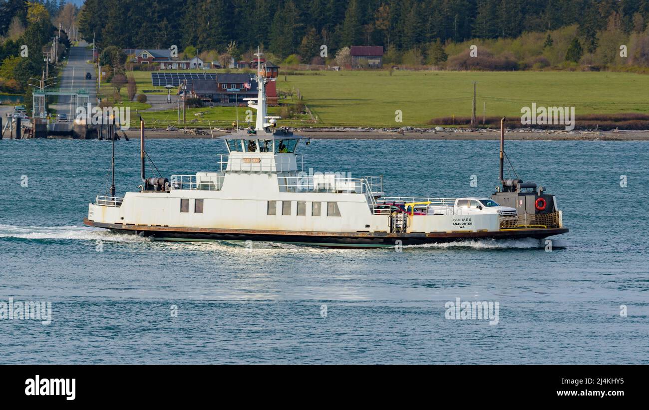 Anacortes, WA, USA - April 12, 2022; Small car ferry Guemes crossing from the island to the mainland at Anacortes in evening light Stock Photo