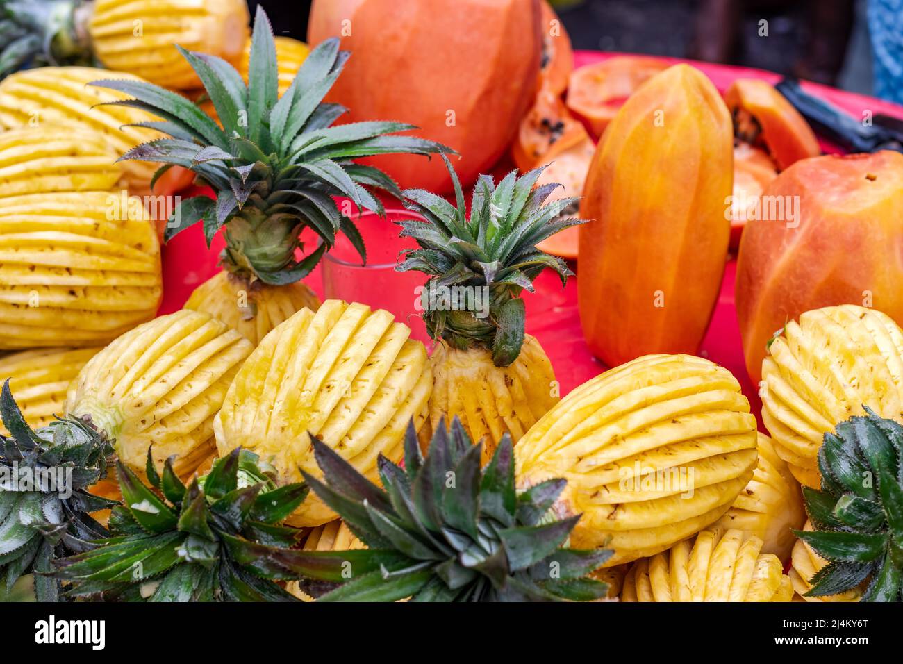Papaya and pineapples with ornamental design on a fruit market Stock