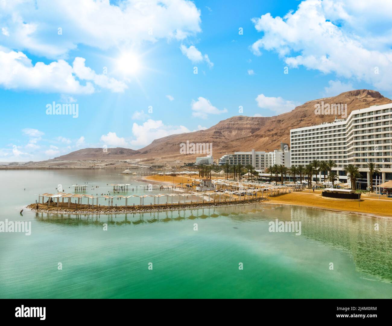 Dead sea beach shore tourist hotels, salt water, daylight sky Ein Bokek aerial view Stock Photo