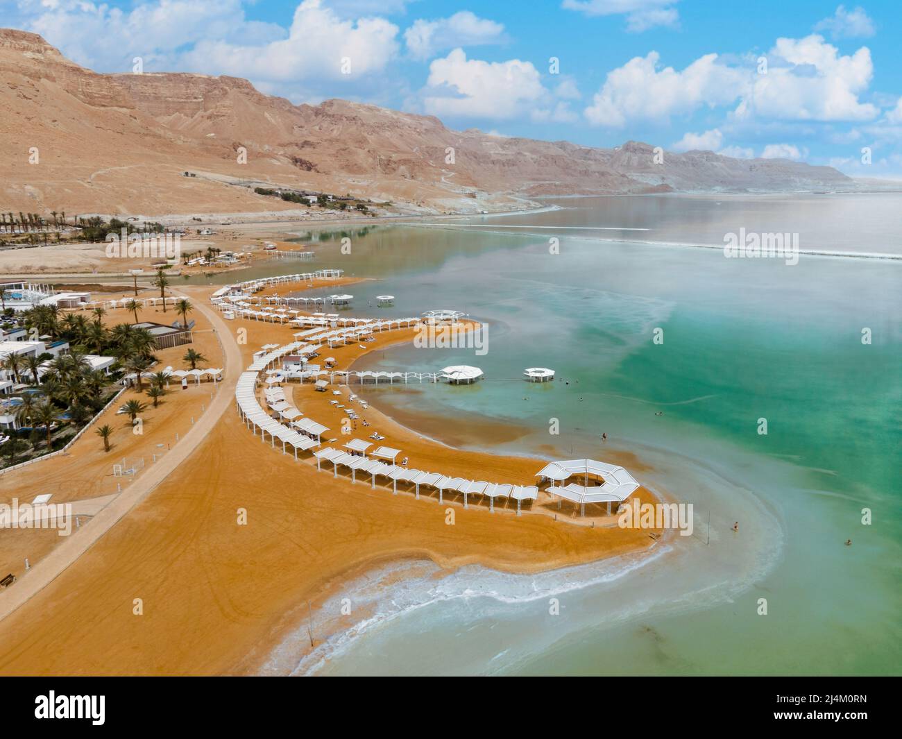 Dead sea beach shore tourist hotels, salt water, daylight Ein Bokek aerial view Stock Photo