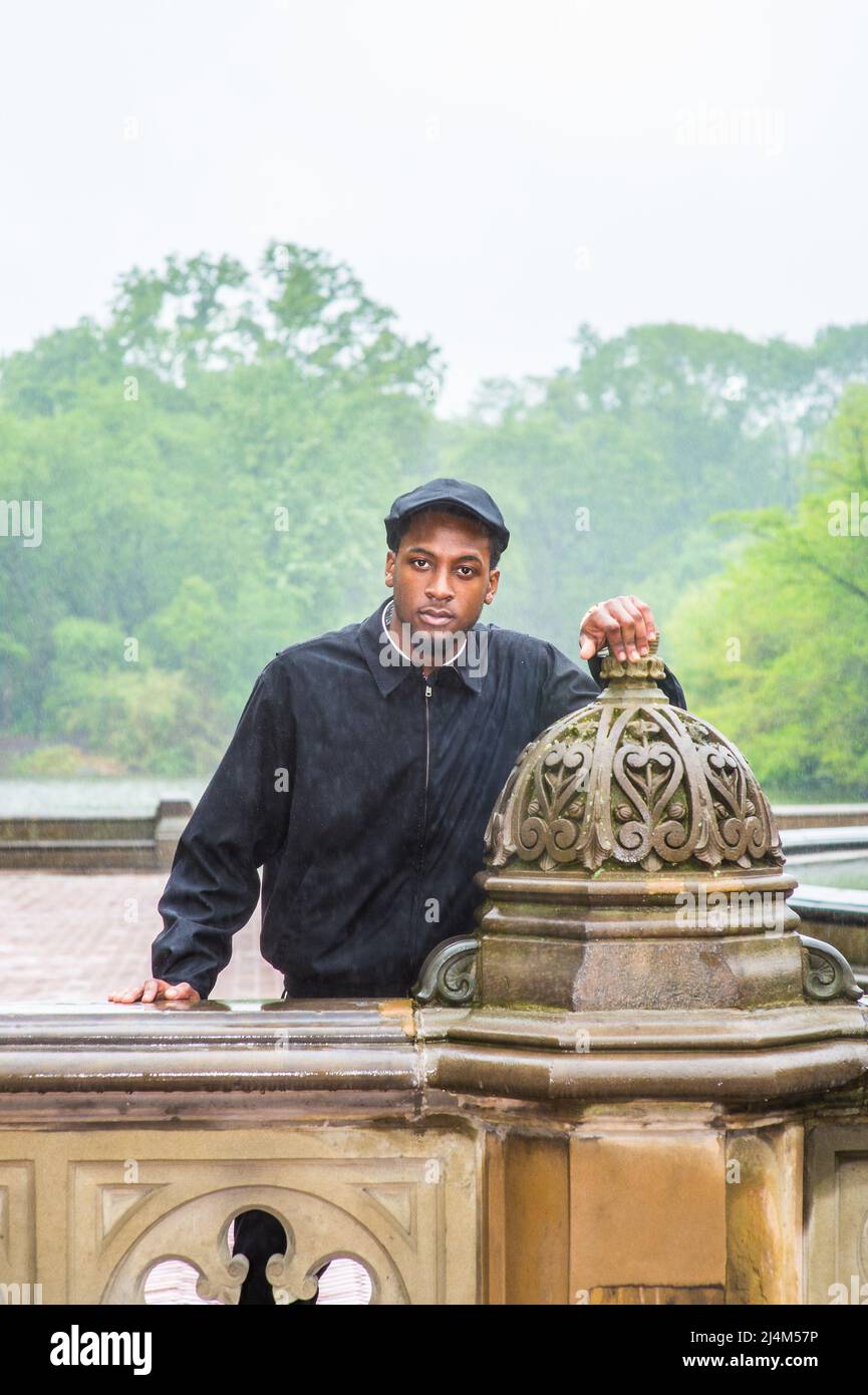 In the rain, a foggy, wet, blur feel. Wearing a waterproof jacket, a ...