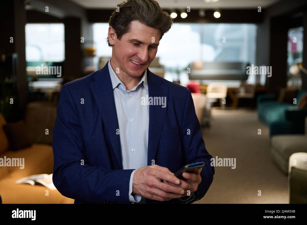 Handsome successful businessman, interior designer, furniture store