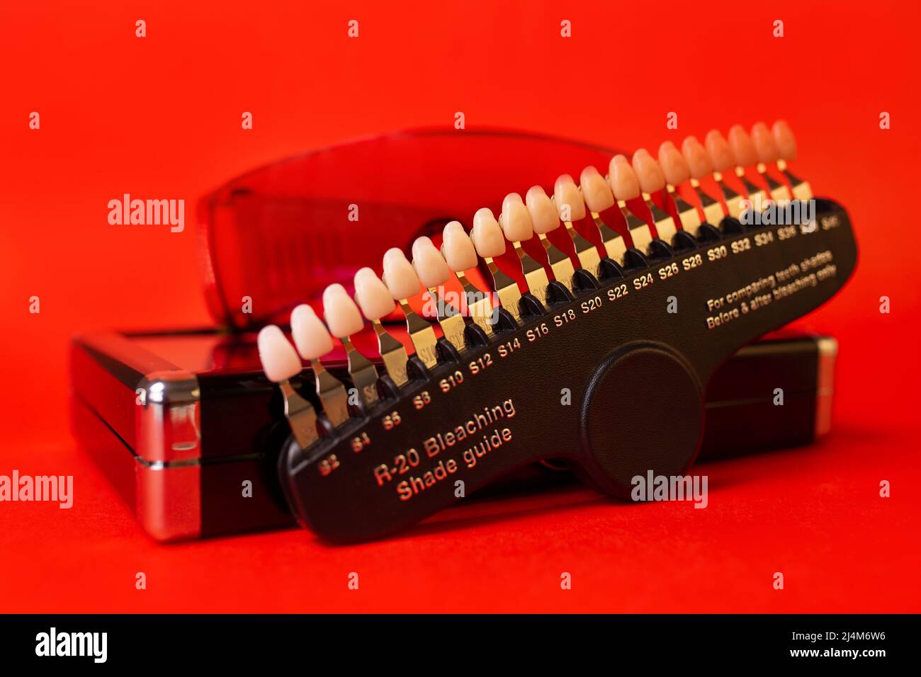 Table of teeth color. Scale on a red background close-up. Stock Photo