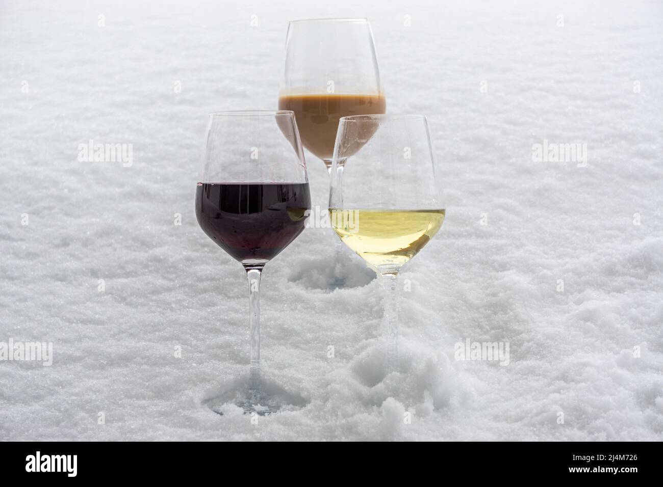 three different glasses of wine on cold snow Stock Photo Alamy