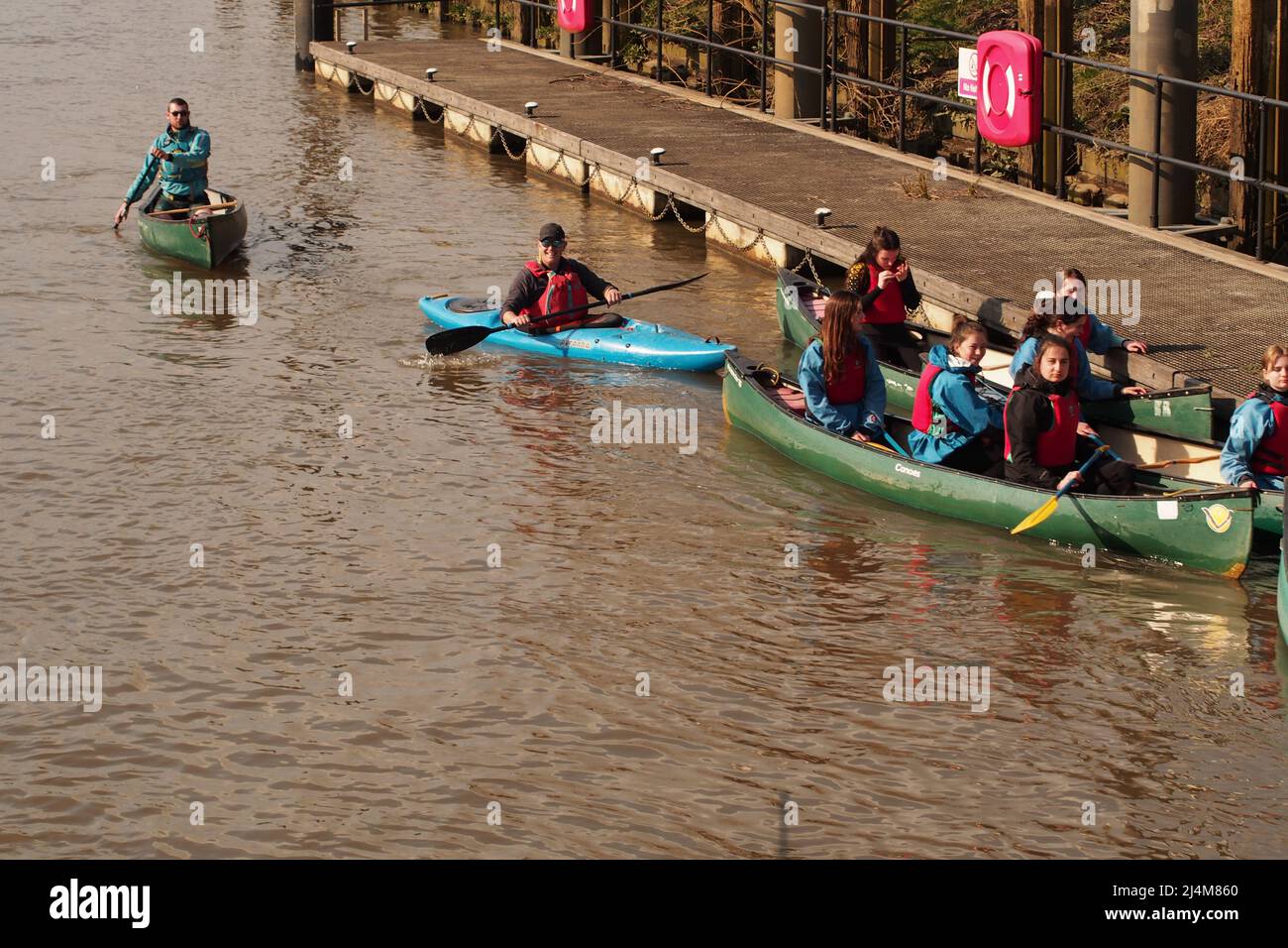 A group of youg people in Canadian canoes on the river Thames near Kingston upon Thames Stock Photo