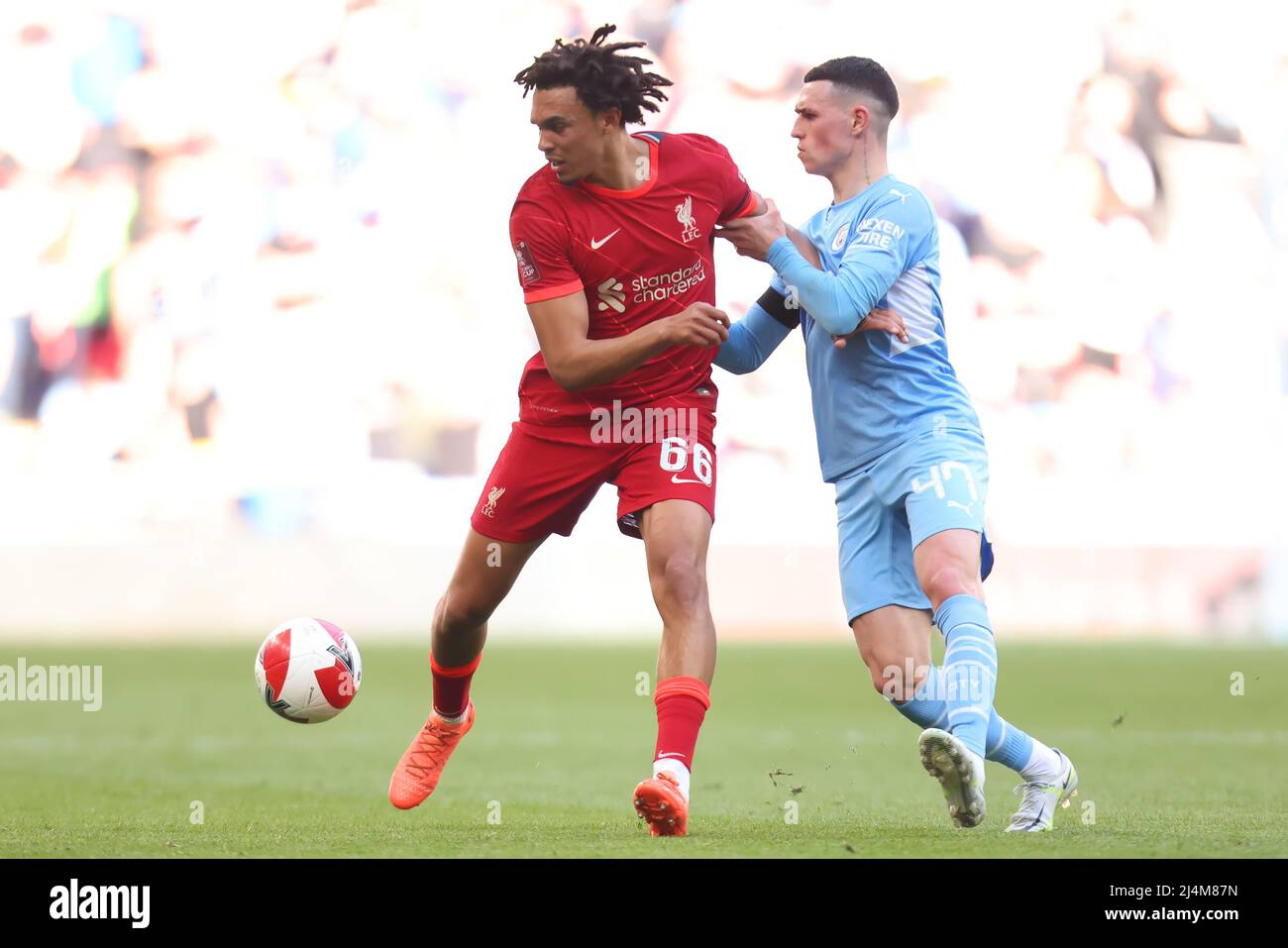 16th April 2022, Wembley Stadium, London England: FA Cup semi-final, Liverpool versus Manchester City: Trent Alexander-Arnold of Liverpool competes for the ball with Phil Foden of Manchester City Stock Photo