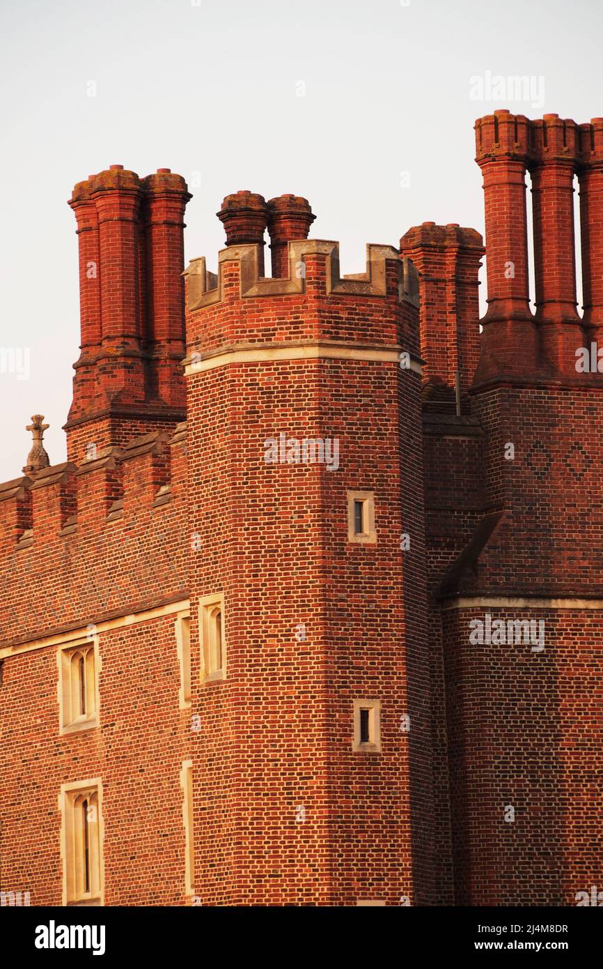 A view of some of the red brick, ornate chimneys of Hampton Court Palace, London, Surrey, England, the home of King Henry VIII Stock Photo