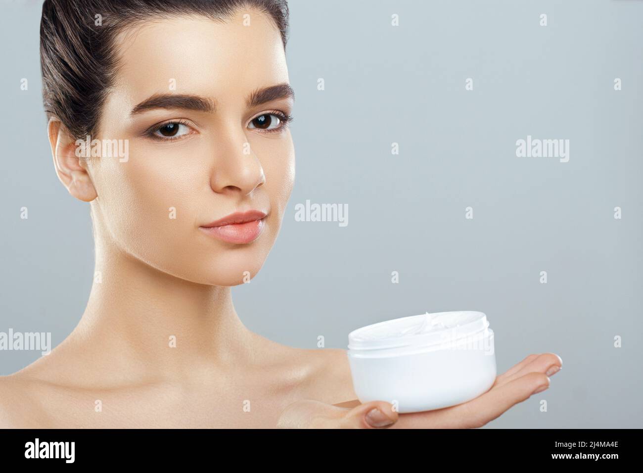 Beautiful Young Woman with Clean Fresh Skin look away. Girl beauty face ...