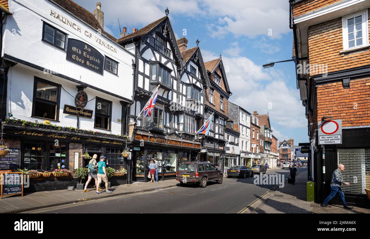 Medieval pub, shops and half timbered buildings in Minster Street, Salisbury, Wiltshire, UK on 16 April 2022 Stock Photo