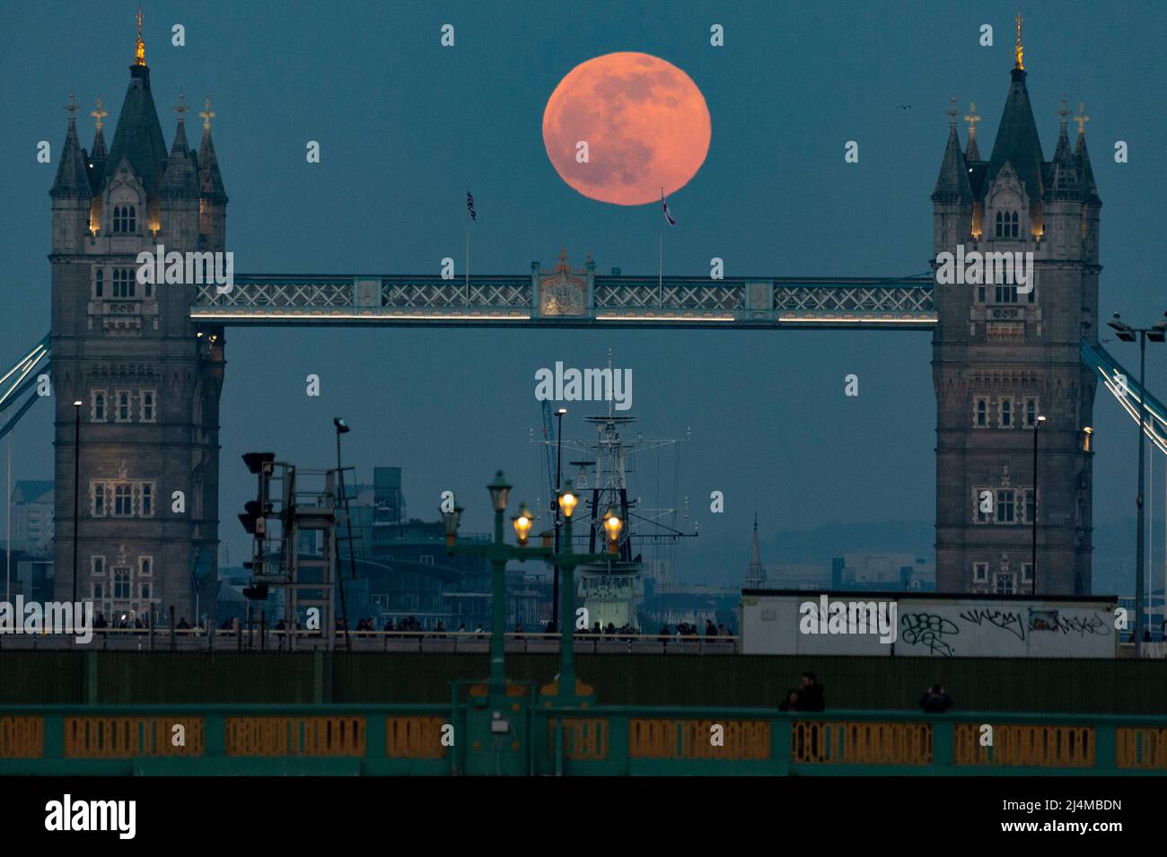 London, UK.  16 April 2022.  UK Weather – April’s full moon, known as a Pink Moon, rises behind Tower Bridge.  According to the Old Farmer’s Almanac, the name Pink Moon comes from the full moon coinciding with early springtime pink blooms of the Phlox subulata, a North American wildflower.  April’s full moon is also the Paschal full moon (the first full Moon of spring) with Easter celebrated on the first Sunday after the Paschal full moon, this year on Sunday, April 17.  Credit: Stephen Chung / Alamy Live News Stock Photo