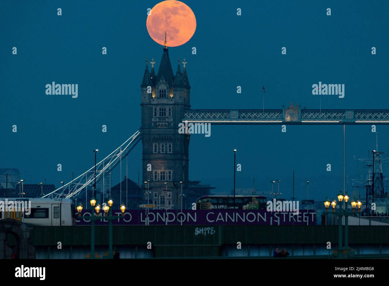 London, UK.  16 April 2022.  UK Weather – April’s full moon, known as a Pink Moon, rises behind Tower Bridge.  According to the Old Farmer’s Almanac, the name Pink Moon comes from the full moon coinciding with early springtime pink blooms of the Phlox subulata, a North American wildflower.  April’s full moon is also the Paschal full moon (the first full Moon of spring) with Easter celebrated on the first Sunday after the Paschal full moon, this year on Sunday, April 17.  Credit: Stephen Chung / Alamy Live News Stock Photo
