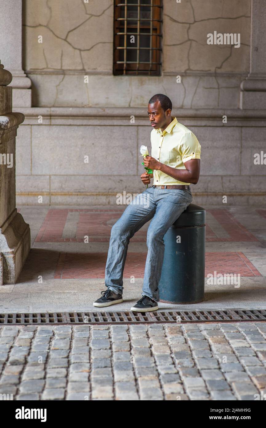 light yellow shirt, gray pants 