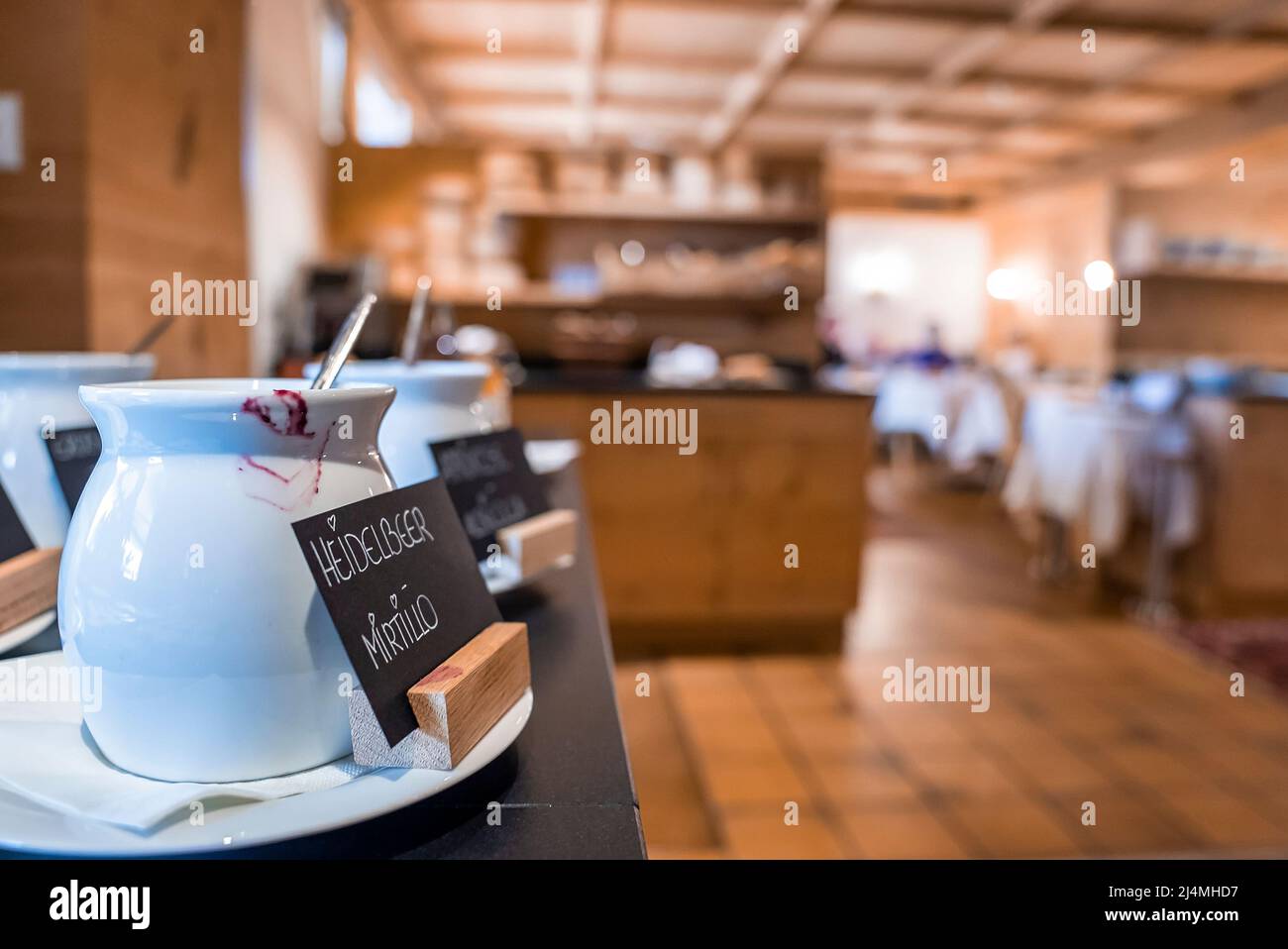 Ceramic jars with labels placed on counter at modern luxury restaurant Stock Photo