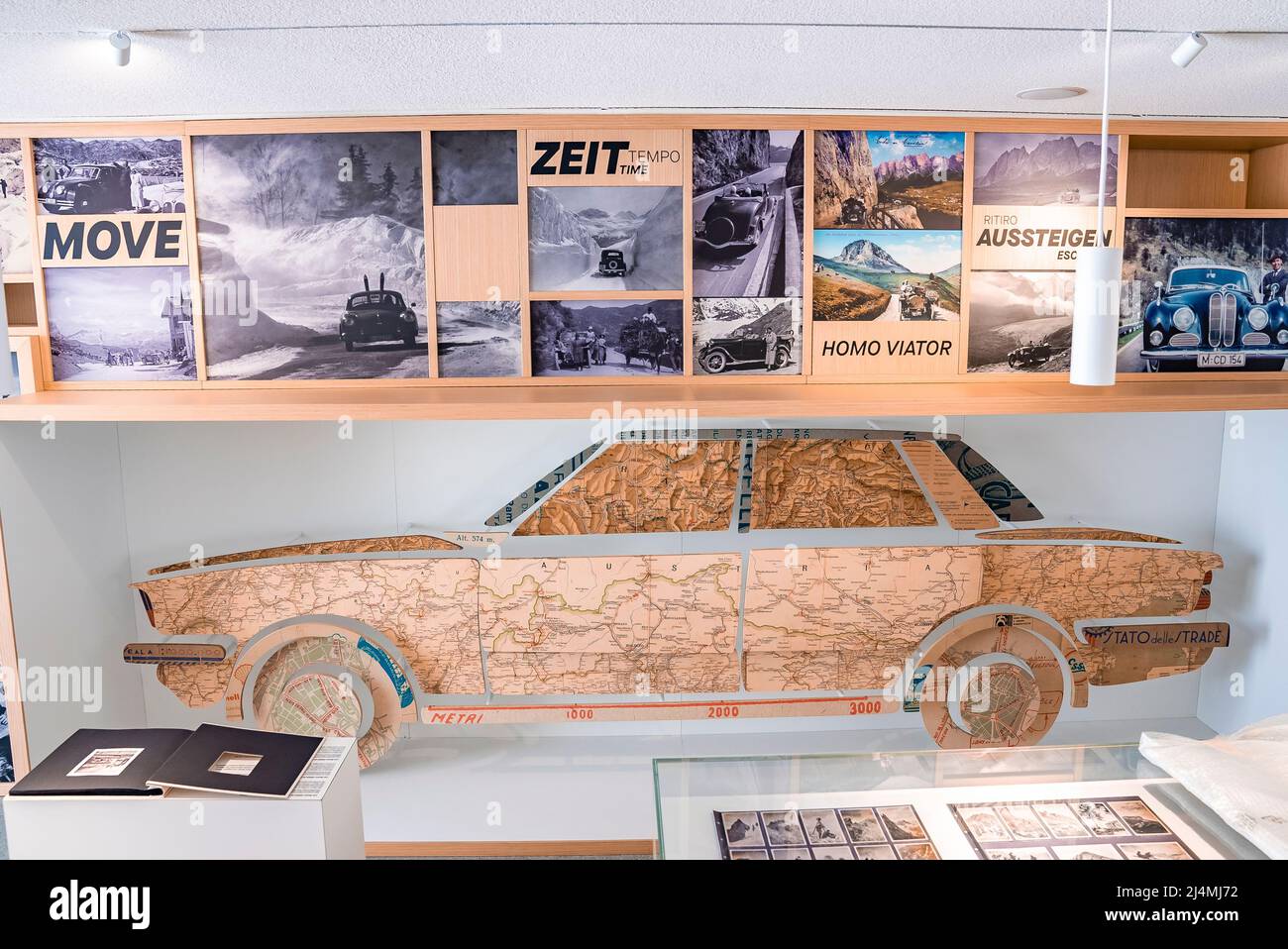 Interior of museum decorated with various photos and car shape made of map Stock Photo