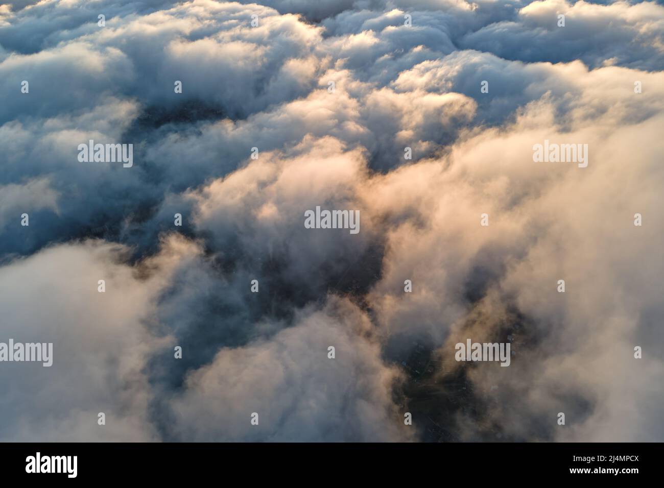 Aerial view from airplane window at high altitude of dense puffy ...