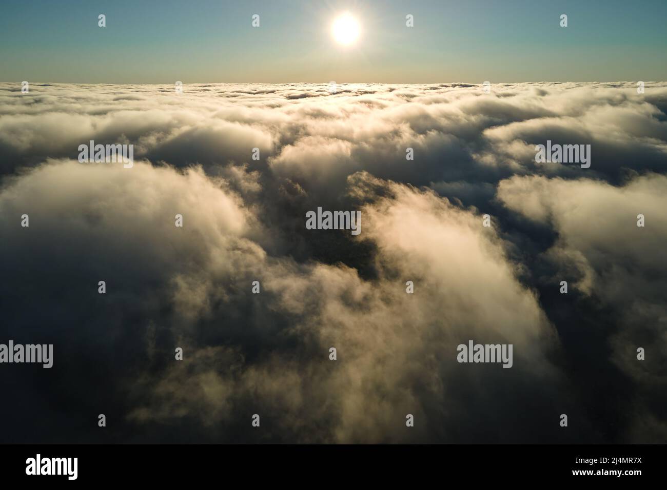 Aerial view at high altitude of dense puffy cumulus clouds forming ...