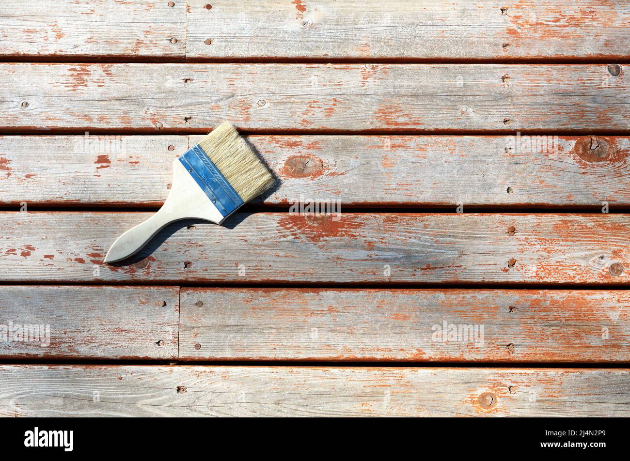 Large paint brush on top of cleaned cedar wood deck for staining purposes Stock Photo Alamy