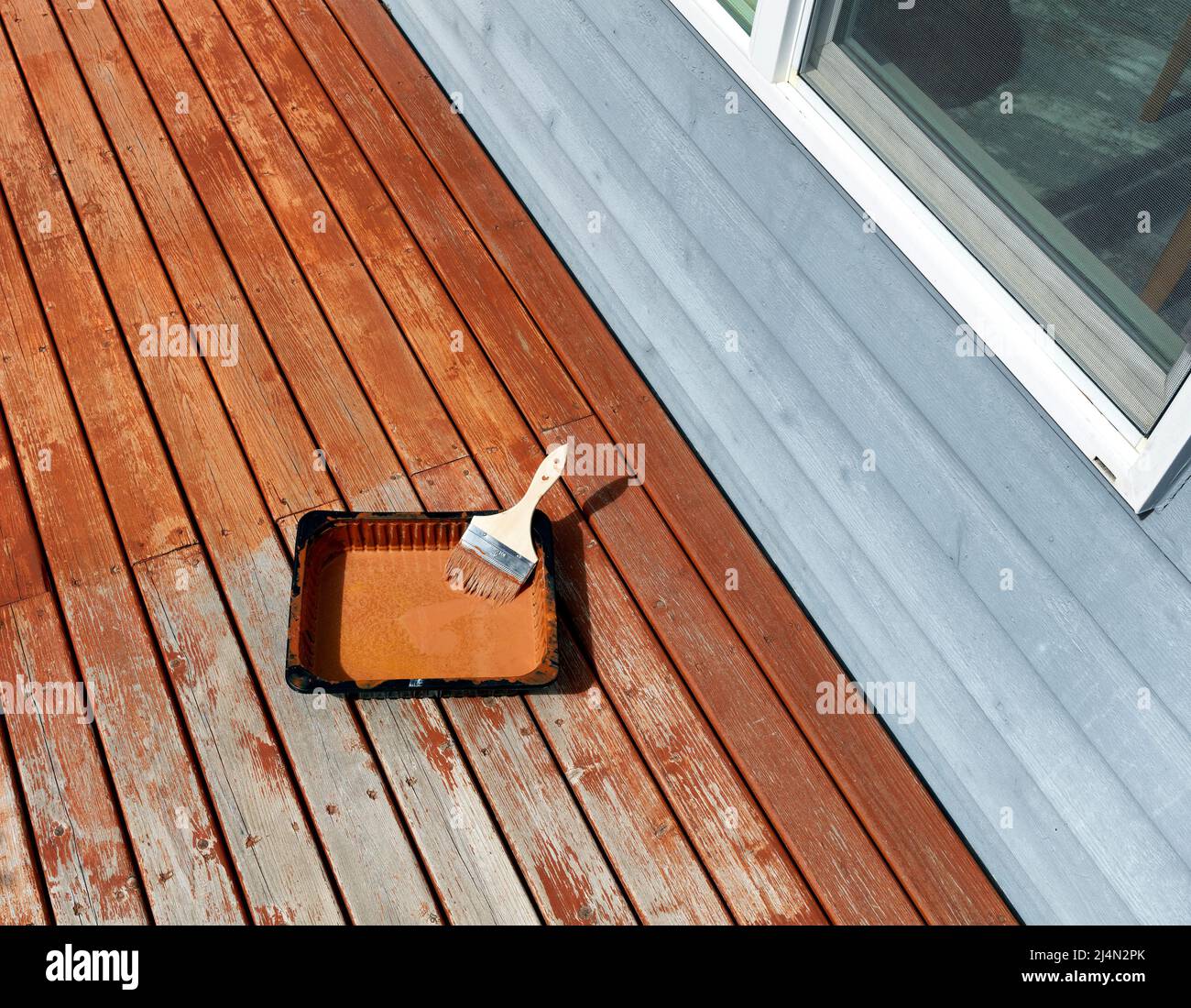 Newly stain outdoor cedar wood deck boards with brush and paint try