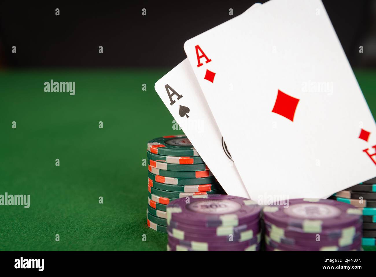 Two aces are seen among stacks of poker chips. Stock Photo