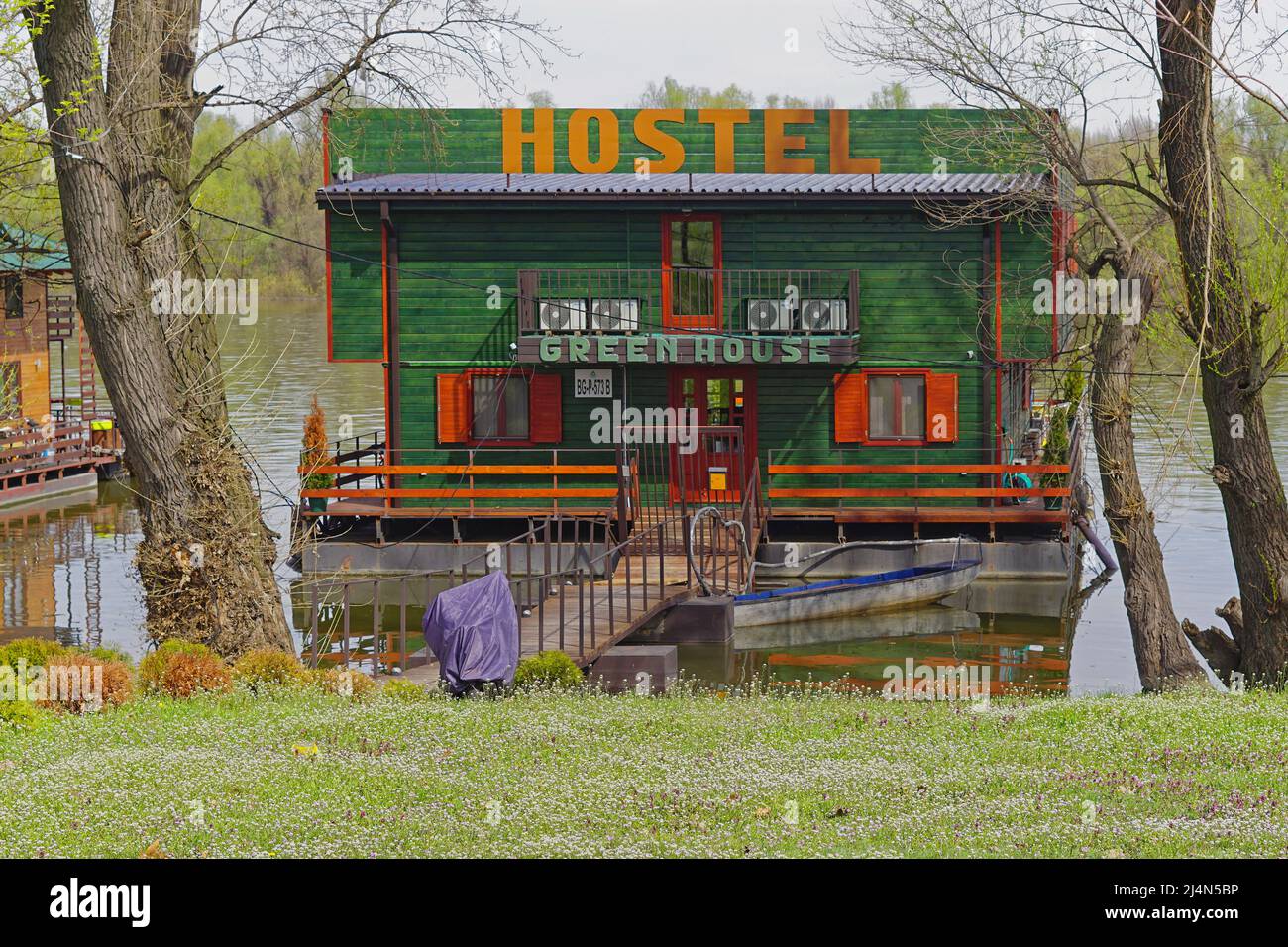 Belgrade, Serbia - April 4, 2018: Hostel green house floating pontoon at Danube river New Belgrade. Stock Photo