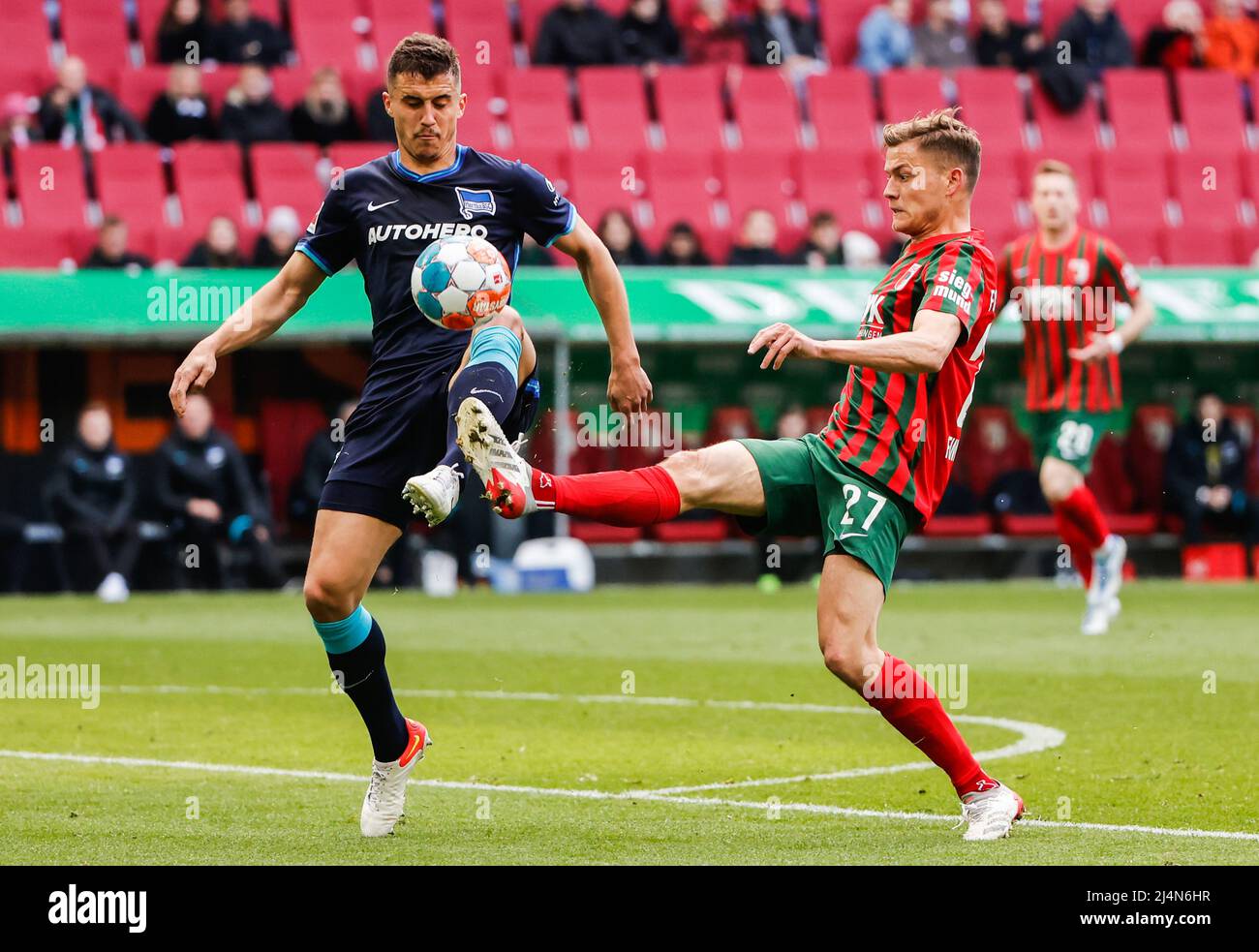 Augsburg, Germany. 16th Apr, 2022. Marc Oliver Kempf (L) of Hertha vies with Alfred Finnbogason of Augsburg during their German Bundesliga match in Augsburg, Germany, April 16, 2022. Hertha won 1-0. Credit: Philippe Ruiz/Xinhua/Alamy Live News Stock Photo