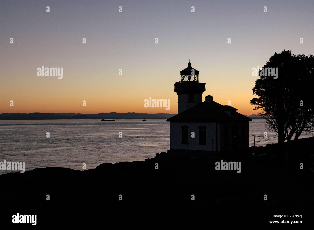Lime Kiln Lighthouse on San Juan Island at sunset Stock Photo