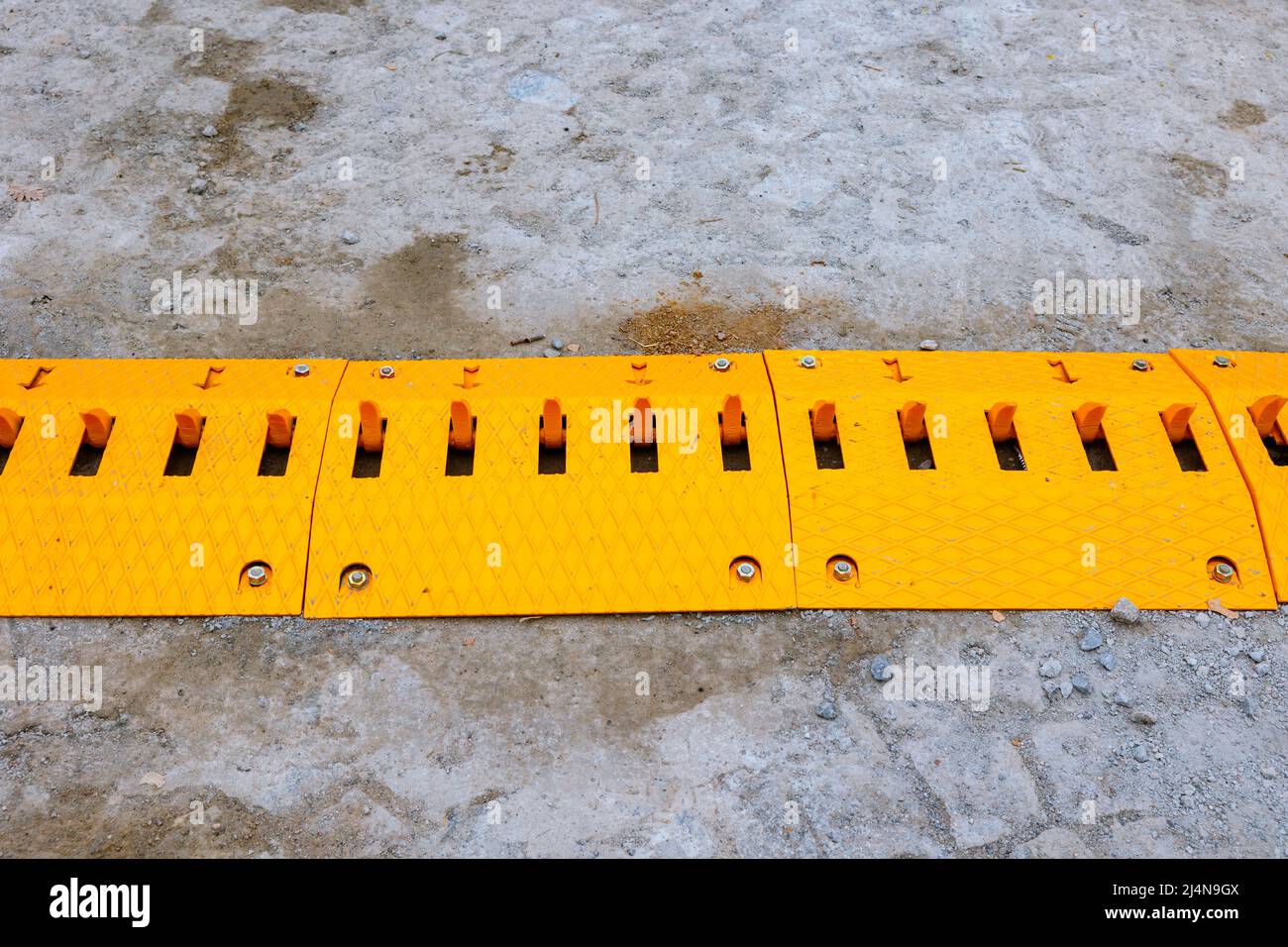 Spike barrier on the road for direction control of traffic. Yellow unidirectional and mechanical