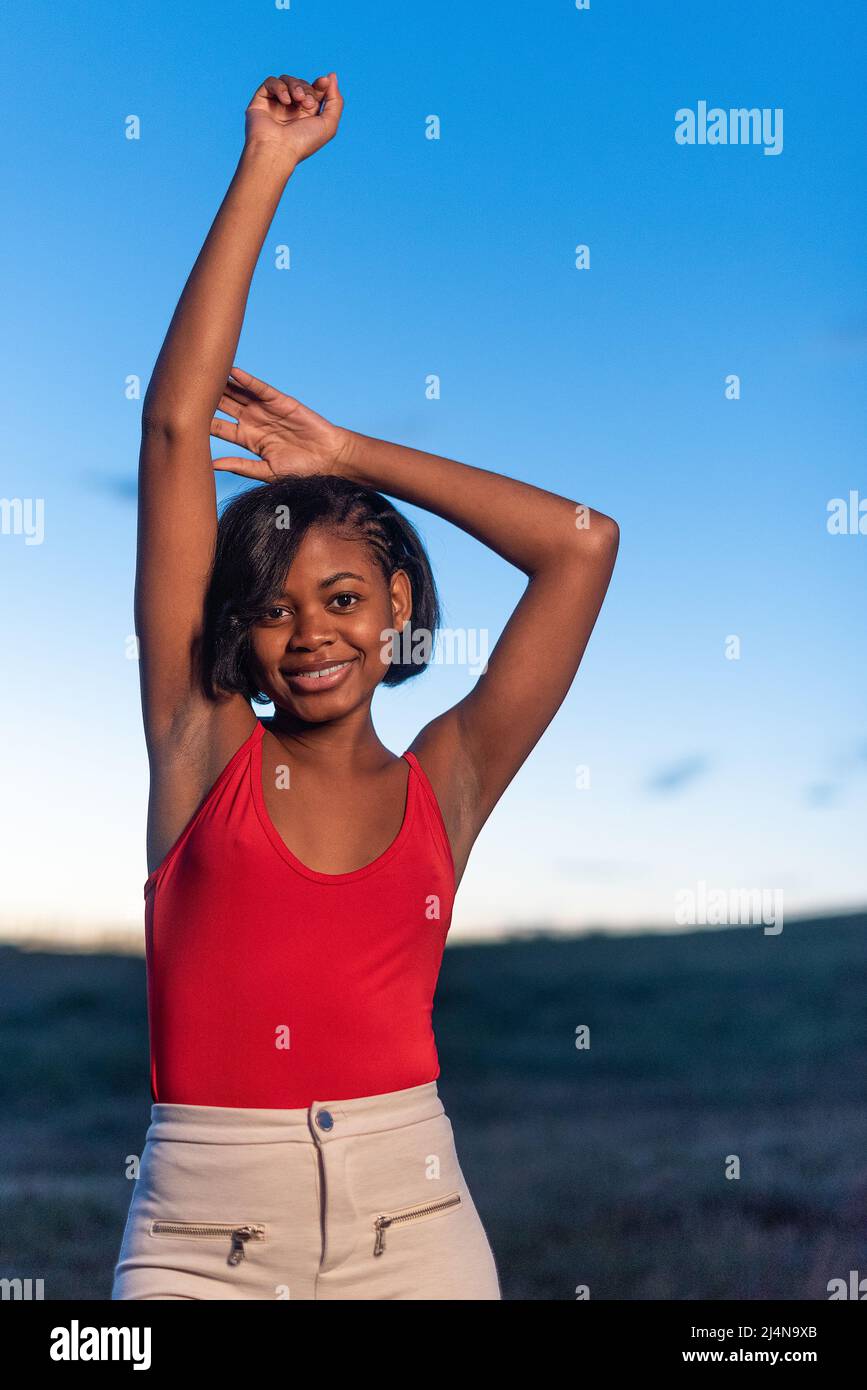 Vertical portrait of a young black woman posing Stock Photo