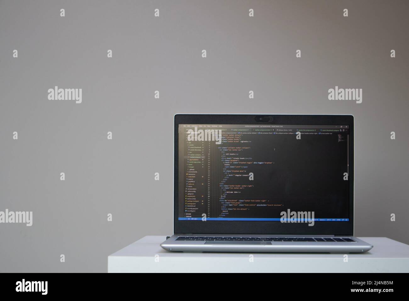 Opened laptop with code on the screen on the table Stock Photo