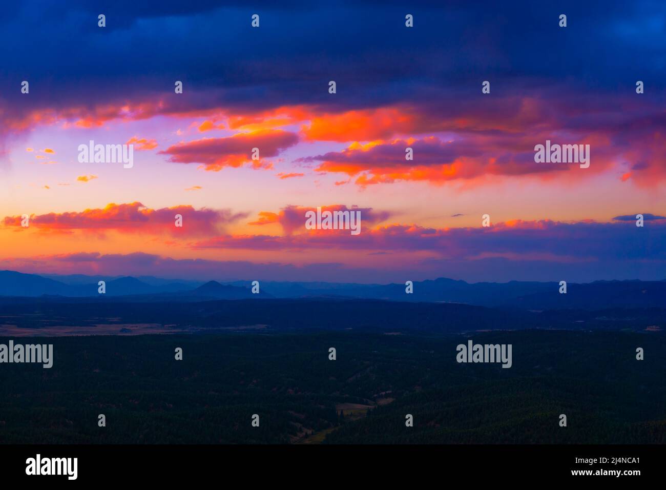 Vivid Sunset Sunrise Clouds Over Vast Scenic View Landscape Stock Photo