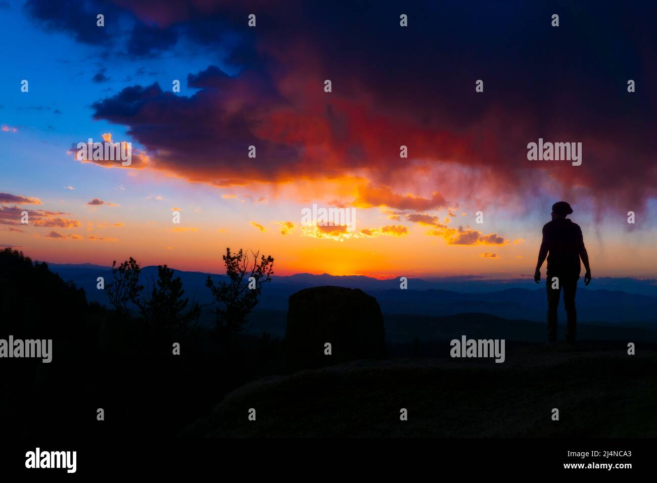 Silhouette Watching Sunrise Sunset From Mountain Top Stock Photo