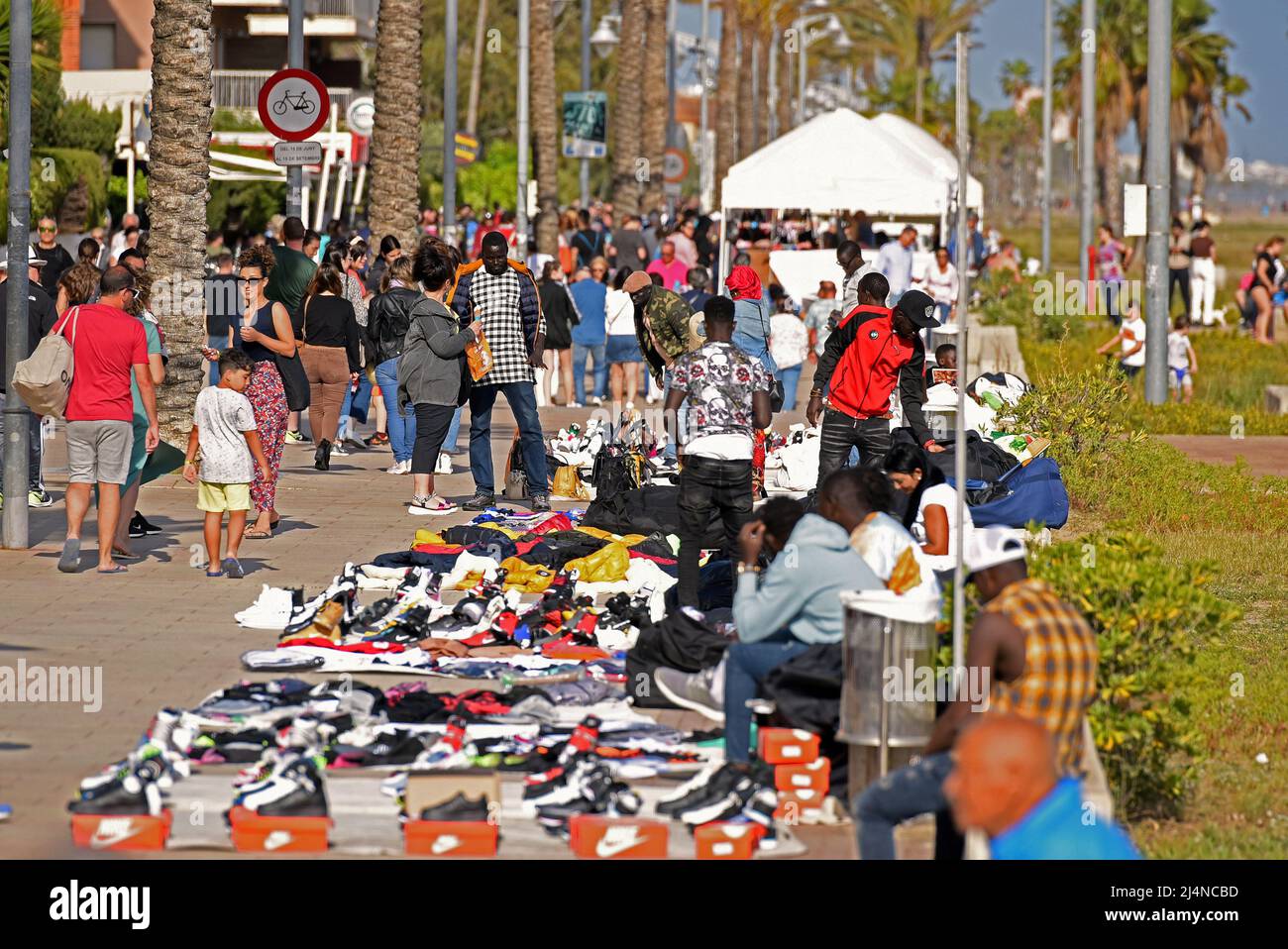 Vendrell, Spain. 16th Apr, 2022. Street vendors exhibit their counterfeit  products for sale on the Paseo Maritimo street. The Vendrell local police  fights daily against the illegal street vendors and forces them
