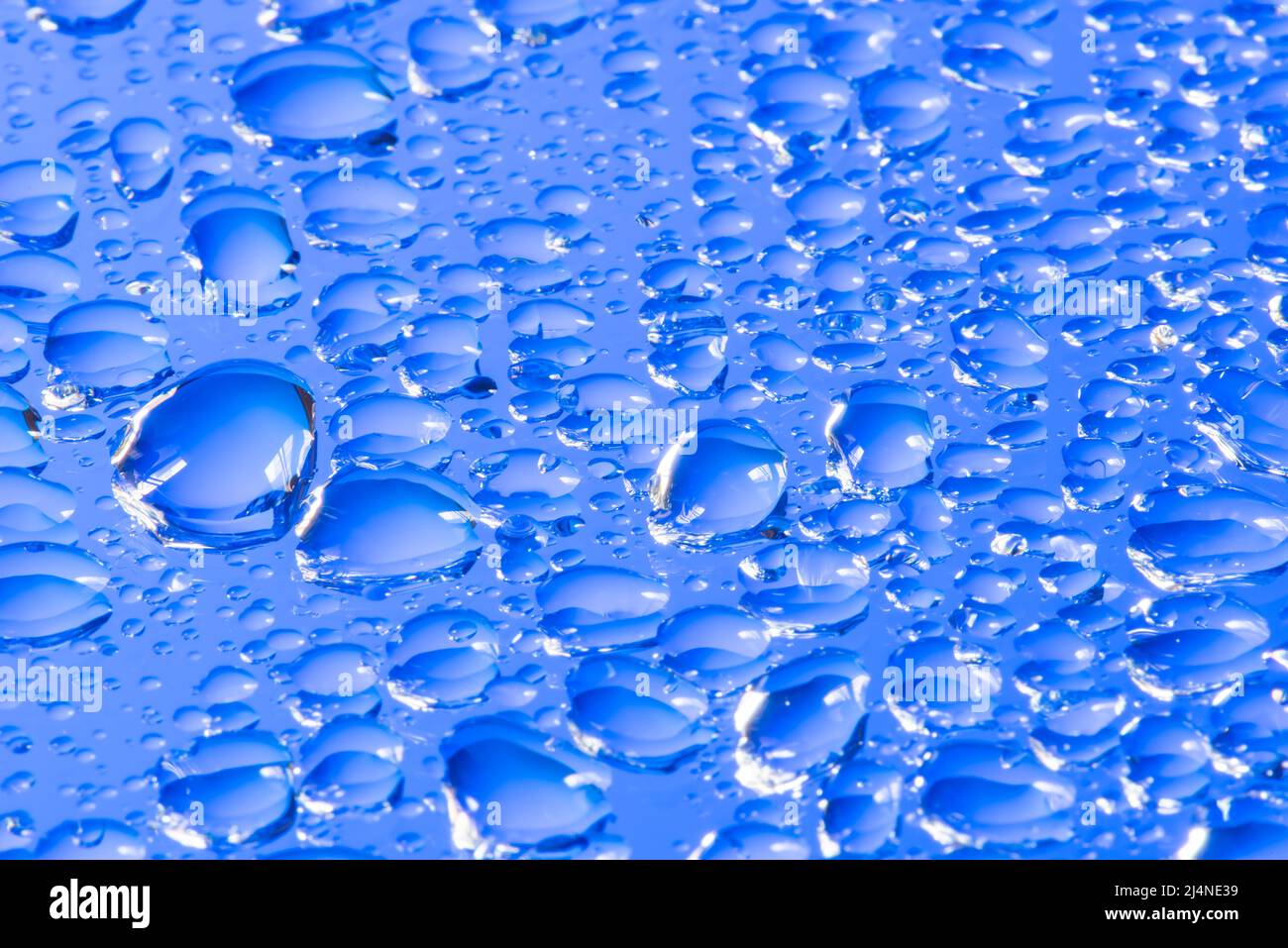 Water drops on a blue glass surface Stock Photo