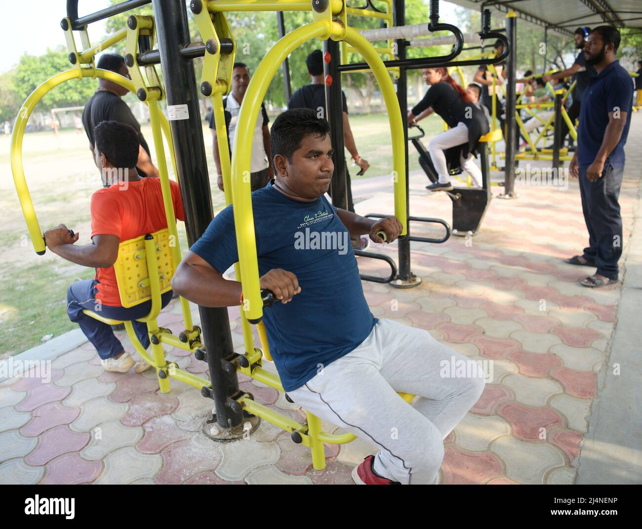 People are doing different exercises in an open gym on World Health Day