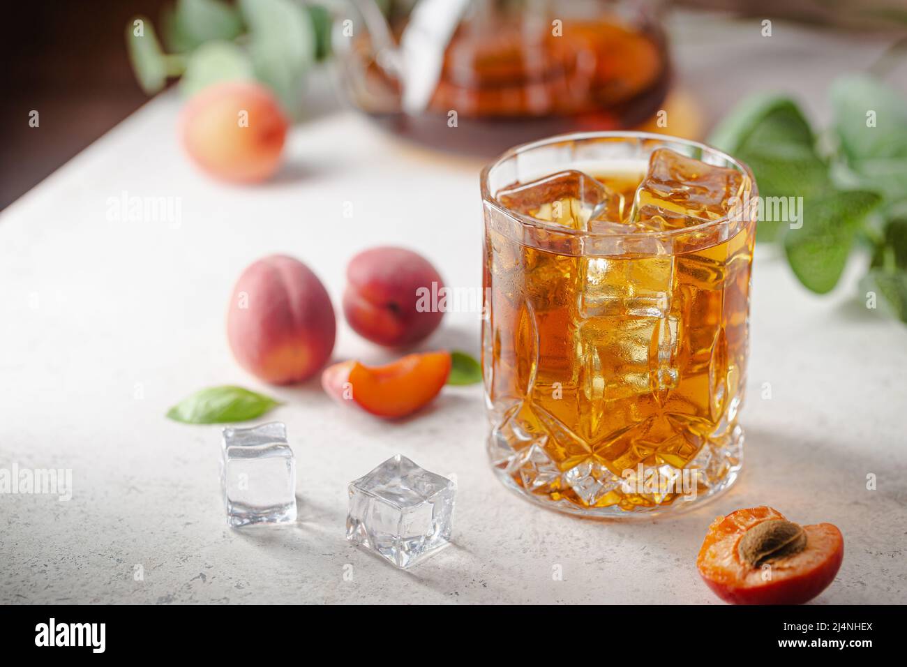 https://c8.alamy.com/comp/2J4NHEX/glass-of-peach-or-apricot-iced-tea-with-fruit-slices-against-white-background-2J4NHEX.jpg