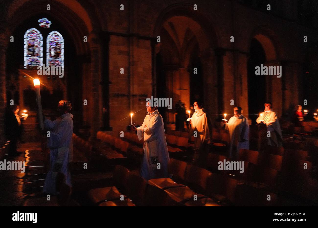 The Paschal candle is carried in a procession during the Dawn Liturgy of Easter service at Chichester Cathedral. Picture date: Sunday April 17, 2022. Stock Photo