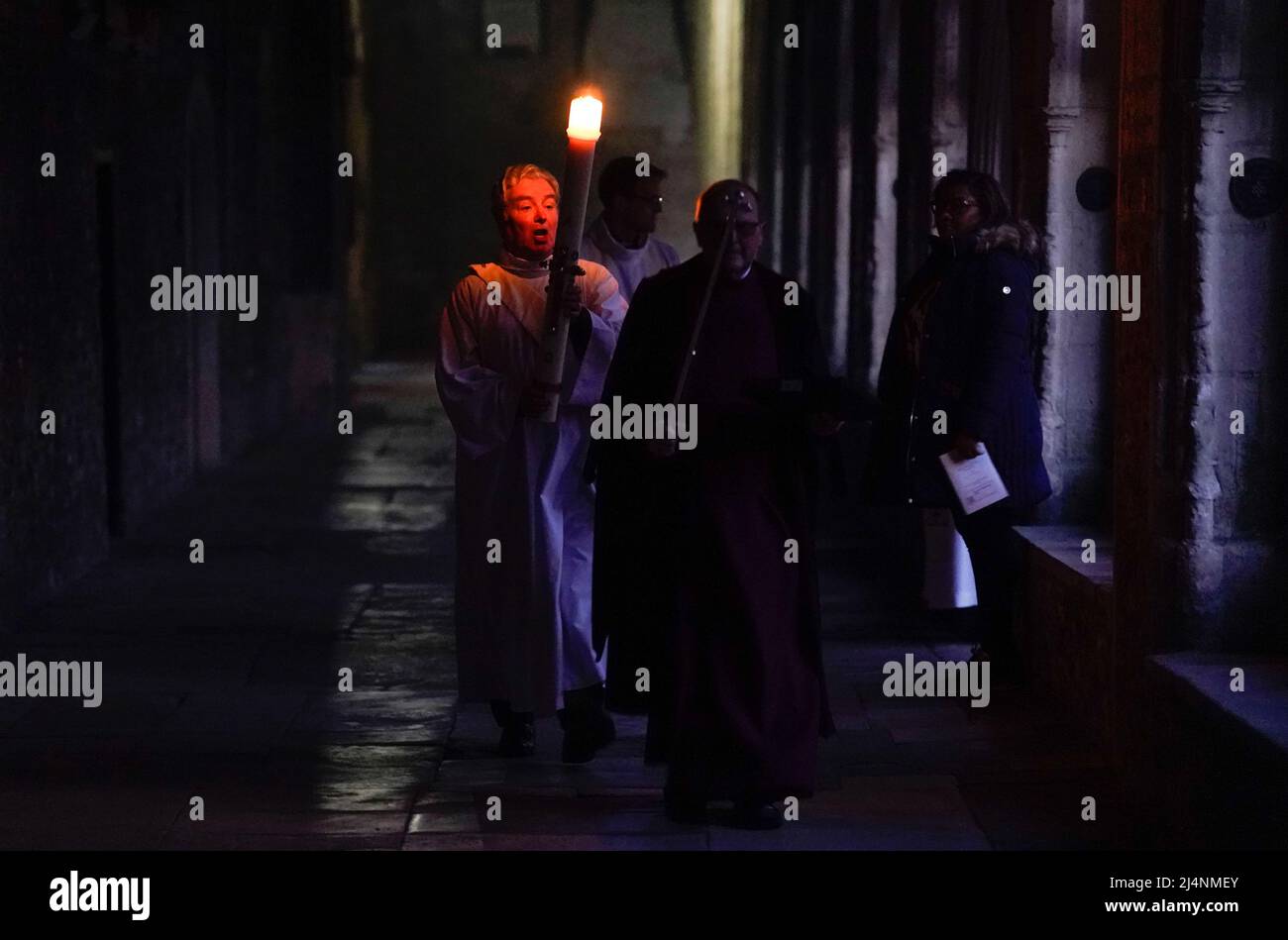 The Paschal candle is carried through the cloisters after being lit during the Dawn Liturgy of Easter service at Chichester Cathedral. Picture date: Sunday April 17, 2022. Stock Photo