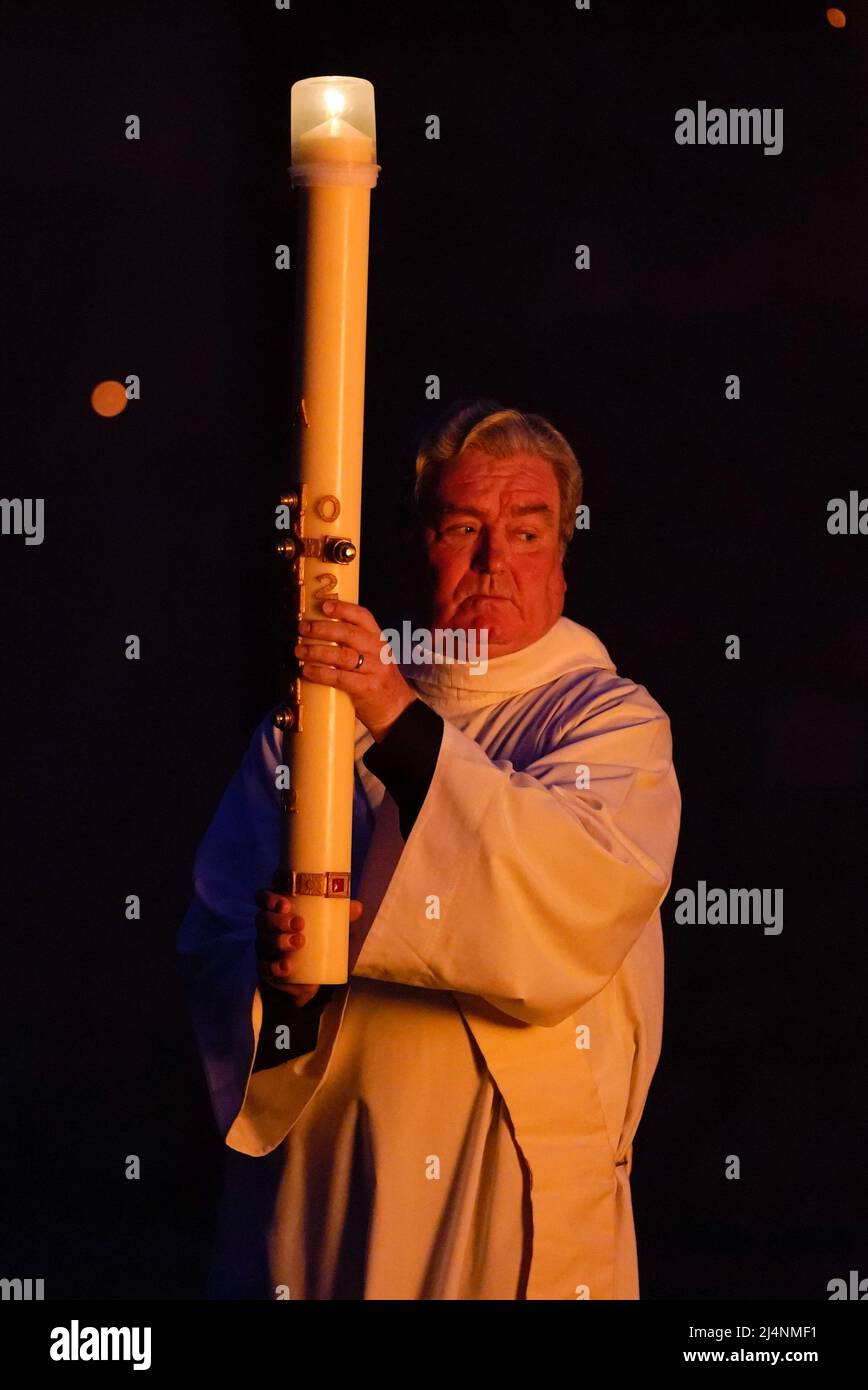 The Paschal candle is carried towards the cloisters after being lit during the Dawn Liturgy of Easter service at Chichester Cathedral. Picture date: Sunday April 17, 2022. Stock Photo