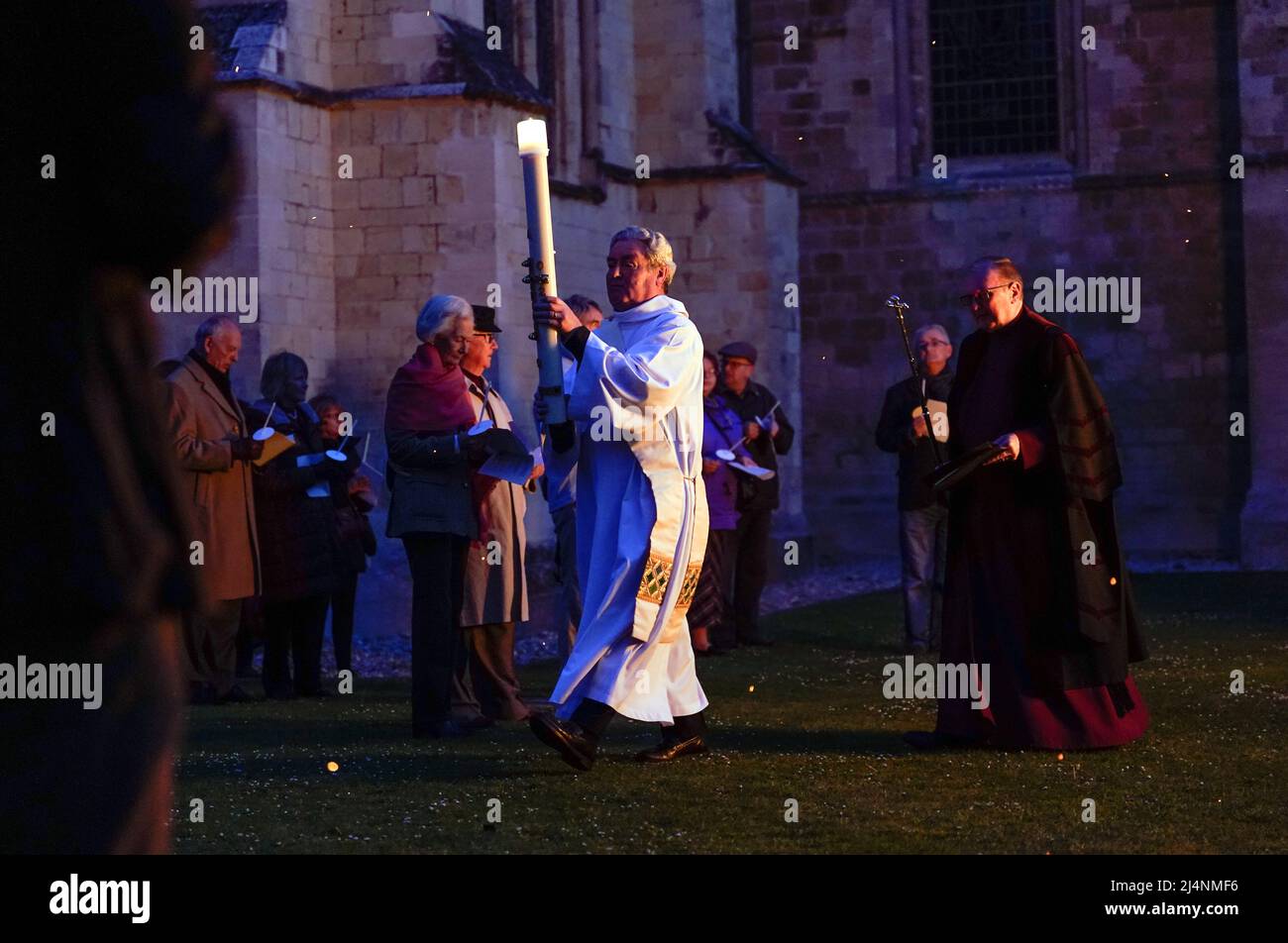 The Paschal candle is carried towards the cloisters after being lit during the Dawn Liturgy of Easter service at Chichester Cathedral. Picture date: Sunday April 17, 2022. Stock Photo
