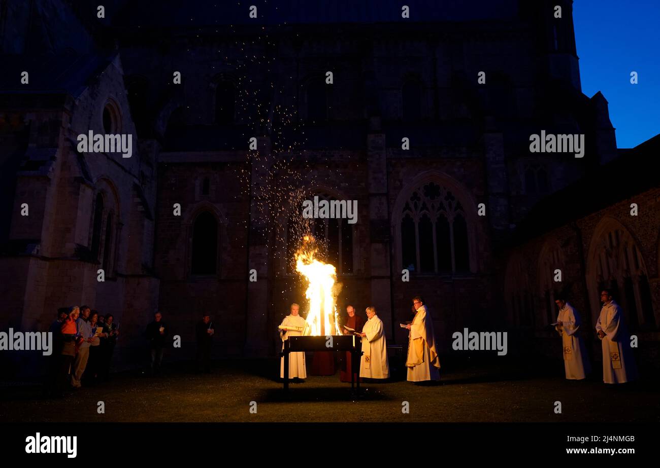 A reading is given next to a fire prior to the Paschal candle being lit during a Dawn Liturgy of Easter service at Chichester Cathedral. Picture date: Sunday April 17, 2022. Stock Photo