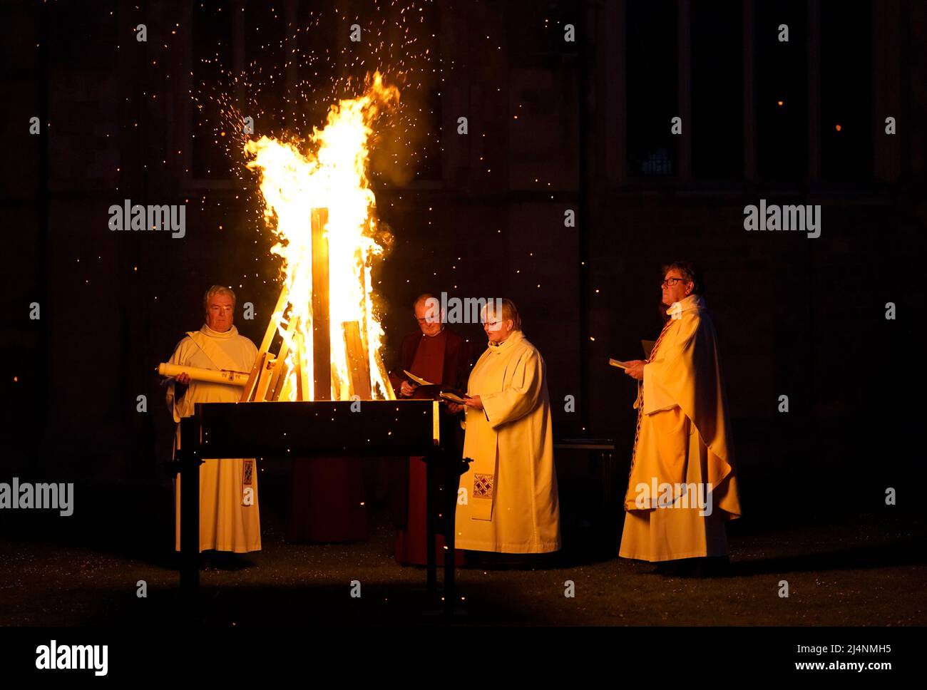 A reading is given next to a fire prior to the Paschal candle being lit during a Dawn Liturgy of Easter service at Chichester Cathedral. Picture date: Sunday April 17, 2022. Stock Photo
