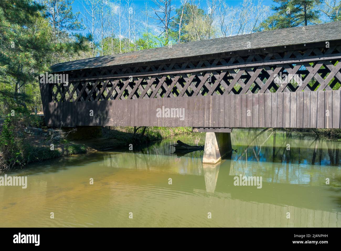 Covered bridge over creek in Cumming, GA Stock Photo