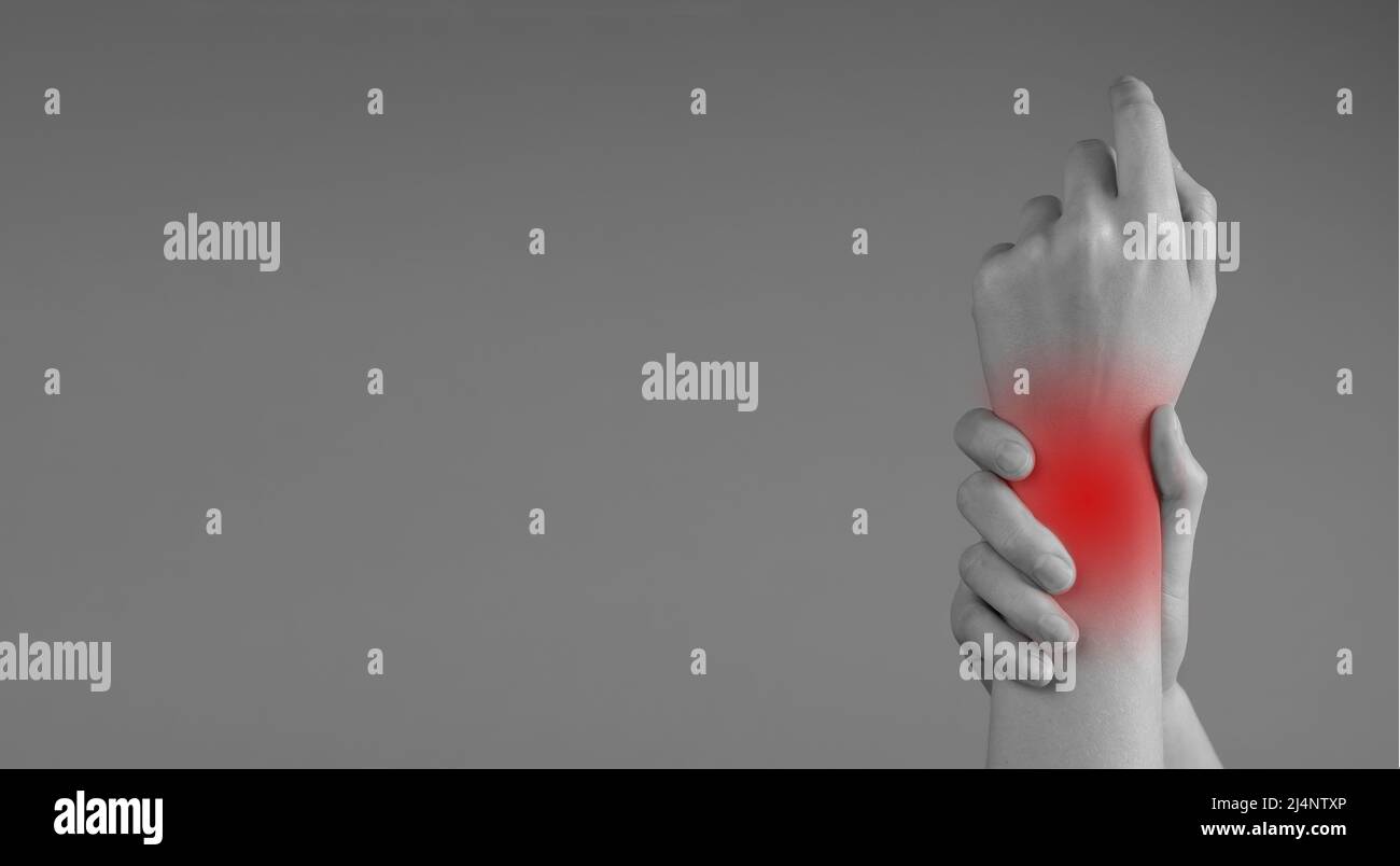 Banner with wrist pain. Woman holding painful hand with red point